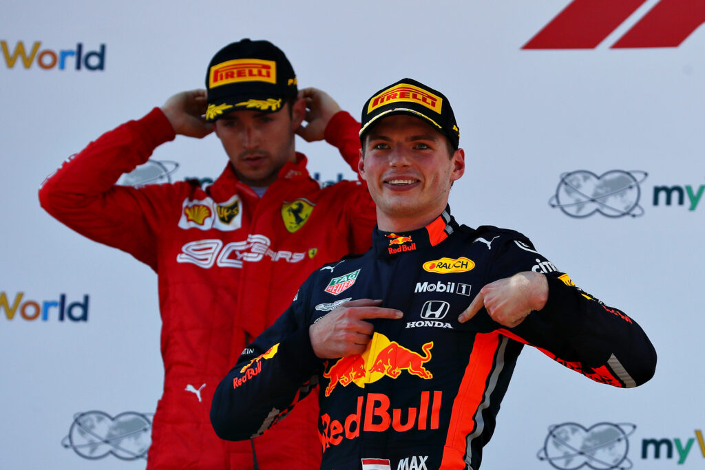 SPIELBERG, AUSTRIA - JUNE 30: Race winner Max Verstappen of Netherlands and Red Bull Racing celebrates on the podium as second placed Charles Leclerc of Monaco and Ferrari looks dejected during the F1 Grand Prix of Austria at Red Bull Ring on June 30, 2019 in Spielberg, Austria. (Photo by Mark Thompson/Getty Images)