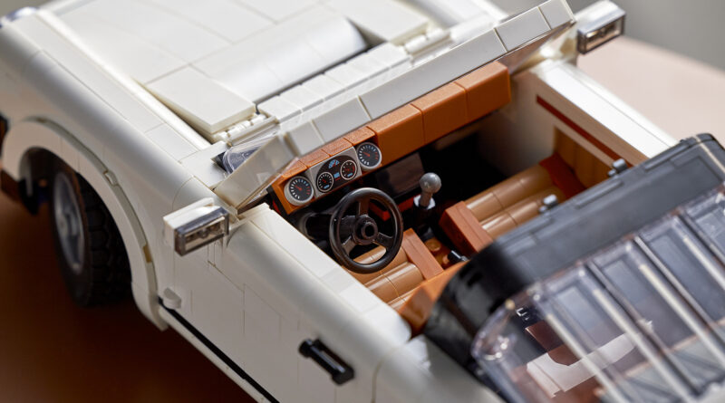 A close up shot of the interior of the new LEGO Porsche set 10295 featuring gear shifter, handbrake, and working steering wheel