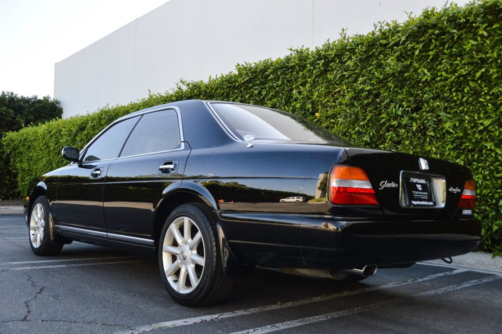 Black 1995 Nissan Gloria sedan rear quarter view