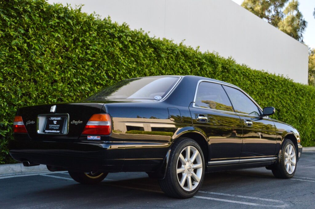Black 1995 Nissan Gloria sedan rear quarter view