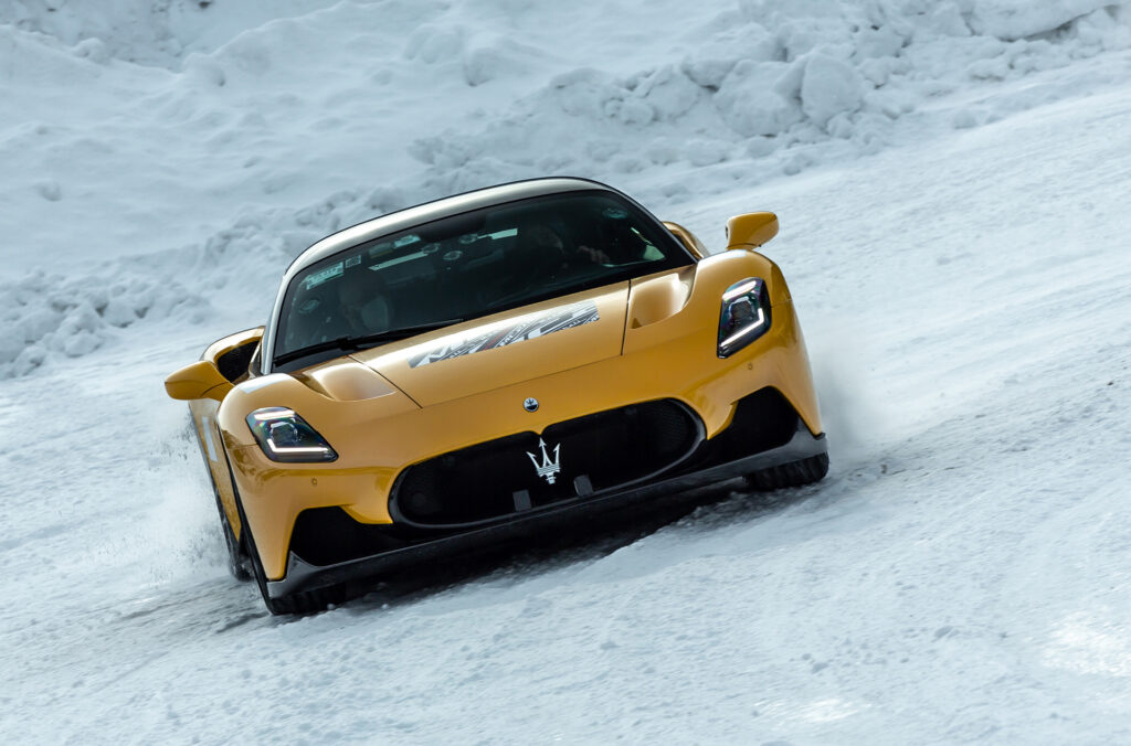 Yellow Maserati MC20 cold weather testing on a snowy track in Italy