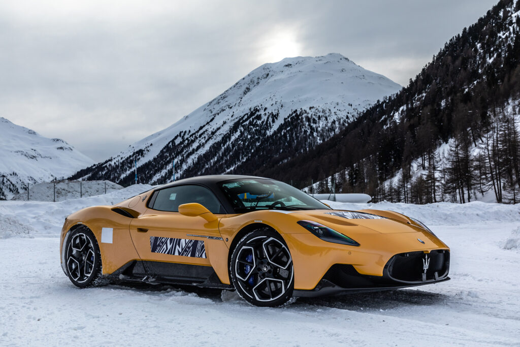 Yellow Maserati MC20 cold weather testing on a snowy track in Italy