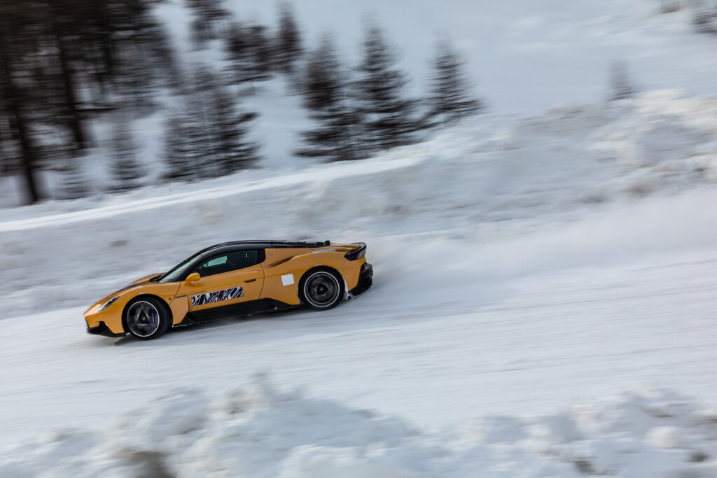 Yellow Maserati MC20 cold weather testing on a snowy track in Italy