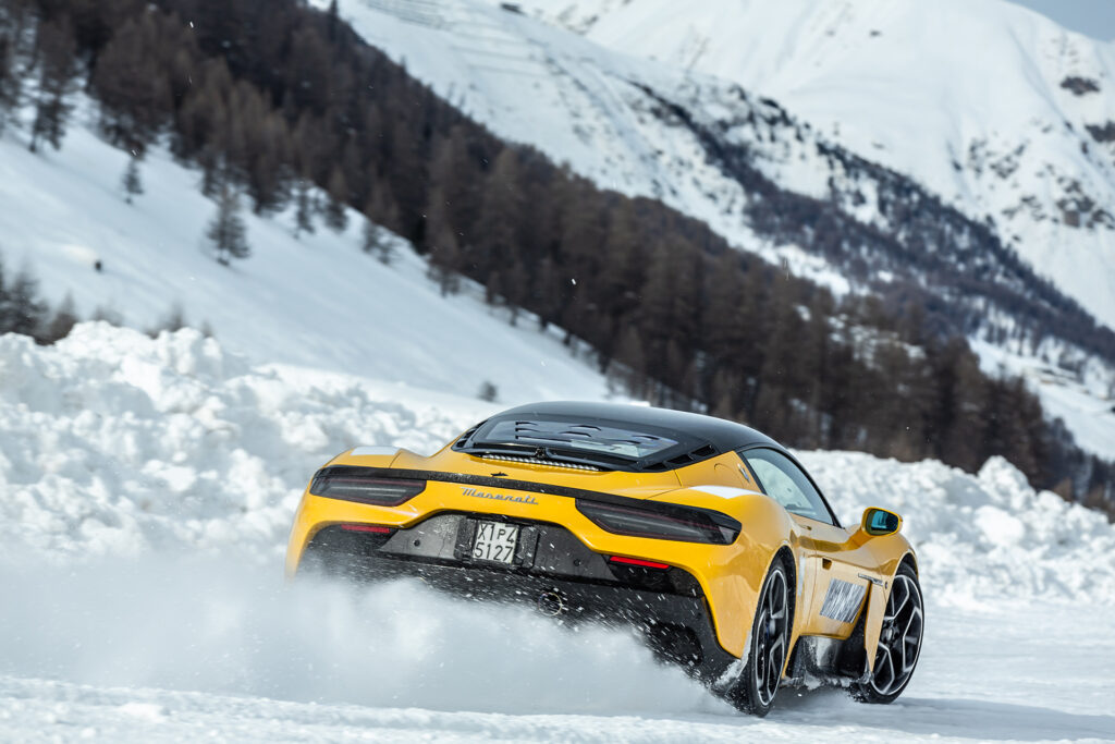 Yellow Maserati MC20 cold weather testing on a snowy track in Italy