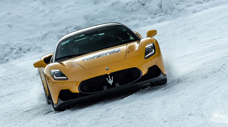 Yellow Maserati MC20 cold weather testing on a snowy track in Italy