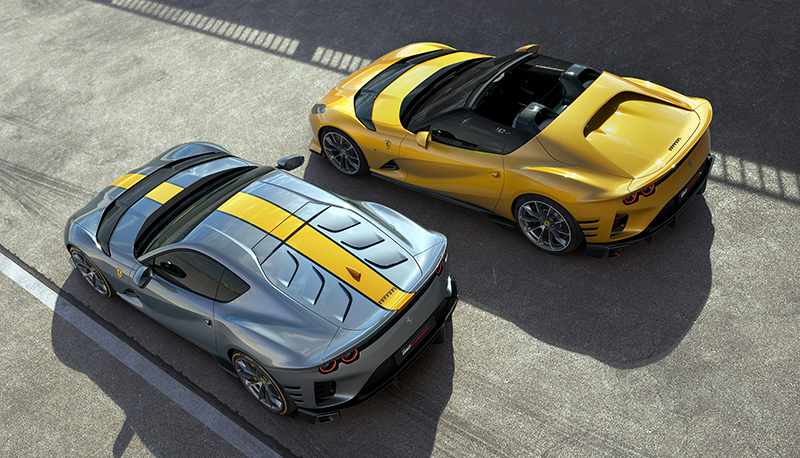 Ferrari 812 Competizione (metallic blue with yellow racing stripe) and Ferrari 812 Competizione A (yellow) parked next to each other with an overhead view
