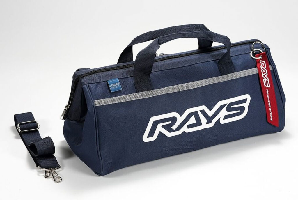 RAYS Engineering tool bag in navy blue. Shown with detachable shoulder strap and red RAYS logo jet tag