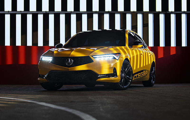 The Acura Integra Prototype shown here photographed in a parking garage with bright yellow paint. This prototype will eventually release in 2022 as the 2023 Acura Integra