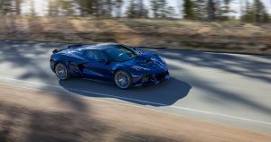 Passenger side view of Chevrolet Corvette ZR1 Convertible in Hysteria Purple driving down a mountain road. Preproduction model shown. Actual production model may vary.