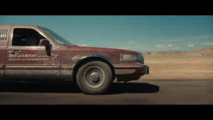 A dark red 1990s Lincoln Town Car Limo as seen in the trailer for Marvel Studios Thunderbolts*