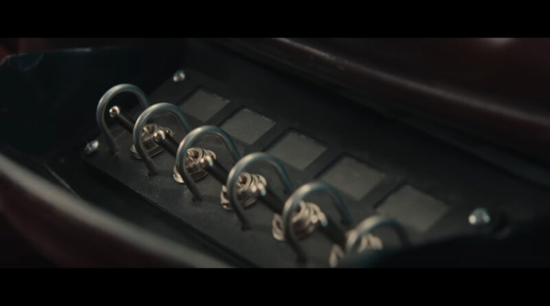 A set of toggle switches inside the glovebox of a 1990s Lincoln Town Car limo as see in the trailer for Marvel Studios' Thunderbolts* film