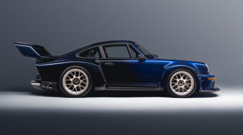 side view showing exterior presented in graduated Fantasia Blue. Rear fender intakes and NACA ducts aid brake and turbocharger cooling. Exterior bright trim is finished in anodized matte black.