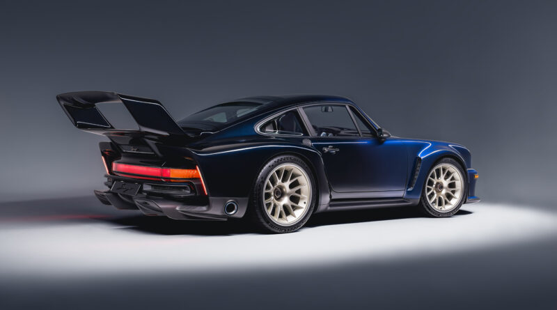 rear ¾ view showing lightweight 19” (front) and 20” (rear) forged magnesium, center-lock wheels in Champagne with Michelin Pilot Sport Cup 2 tires.
