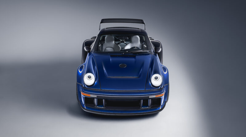 Front view showing track-focused front fascia. A central front intake and hood vent optimize cooling performance.