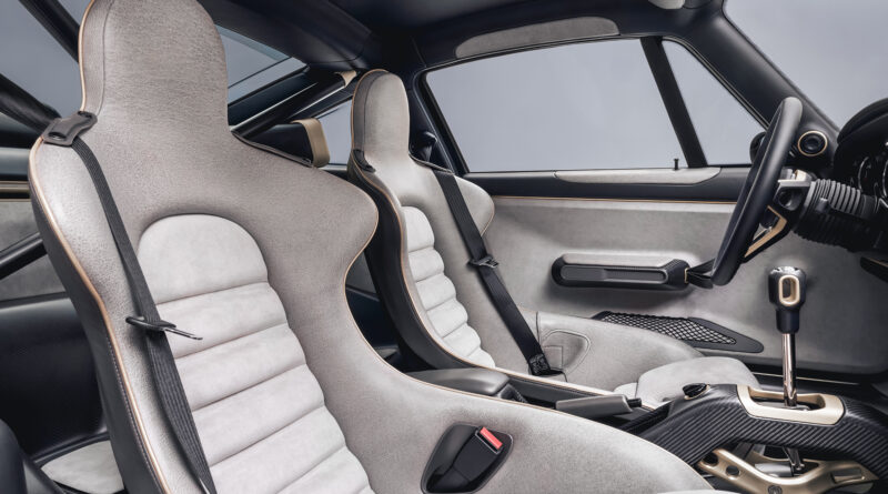 Interior cabin view. Seats are trimmed in Pebbled Grey leather with seat centers finished in Pearl Grey Alcantara. Seat piping is presented in Metallic Champagne leather. The rear seat environment is finished in carbon fiber with X-brace.
